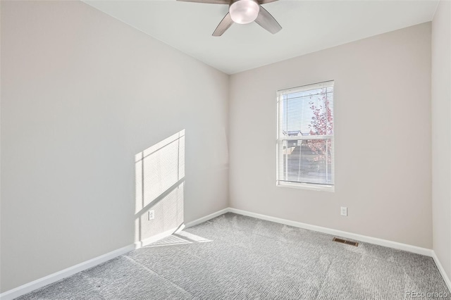 spare room featuring ceiling fan and carpet floors