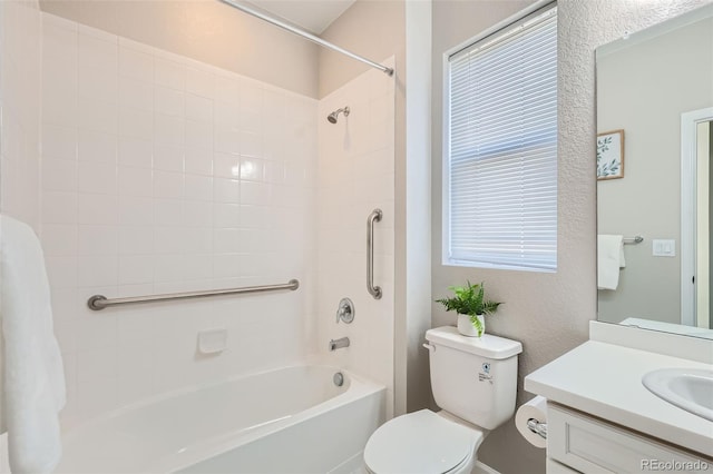 full bathroom featuring vanity, tiled shower / bath combo, and toilet