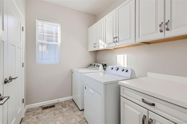 laundry area featuring cabinets and separate washer and dryer