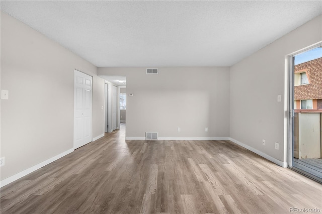 10211 Ura Ln Unit 1-202, Thornton, CO 80260 - unfurnished living room featuring light wood finished floors and baseboards