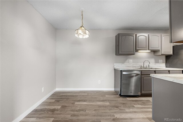 10211 Ura Ln Unit 1-202, Thornton, CO 80260 - kitchen featuring dishwasher, light countertops, gray cabinets, a sink, and light wood-style flooring