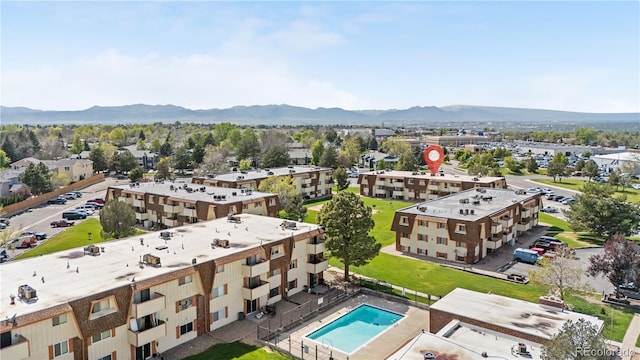 10211 Ura Ln Unit 1-202, Thornton, CO 80260 - drone / aerial view of a mountainous background and a pool area