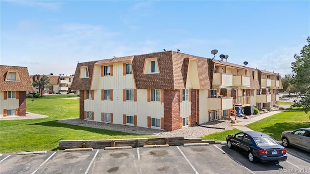 10211 Ura Ln Unit 1-202, Thornton, CO 80260 - view of building exterior featuring uncovered parking and a residential view