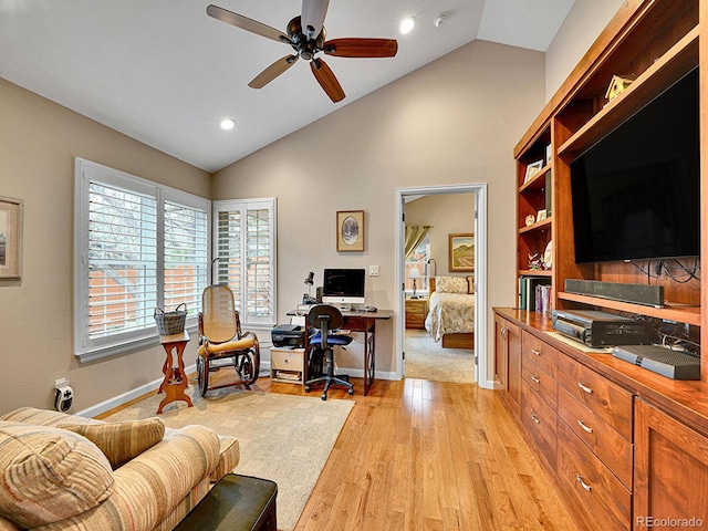 home office featuring baseboards, ceiling fan, vaulted ceiling, and light wood-type flooring
