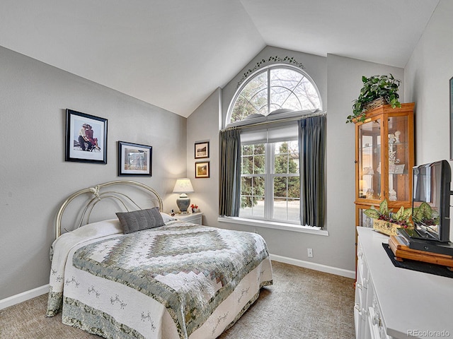 bedroom with baseboards, light carpet, and vaulted ceiling