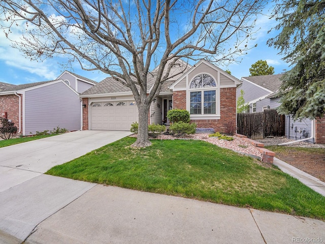 single story home featuring a front lawn, fence, brick siding, an attached garage, and driveway