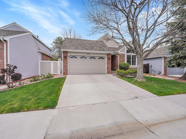 single story home featuring a garage, a front lawn, brick siding, a shingled roof, and driveway