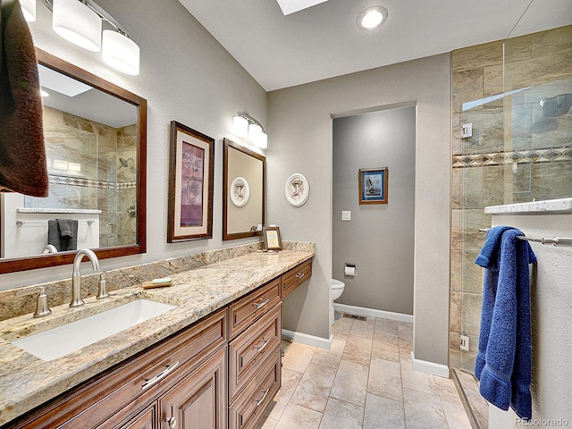 full bath with double vanity, a sink, baseboards, toilet, and tiled shower