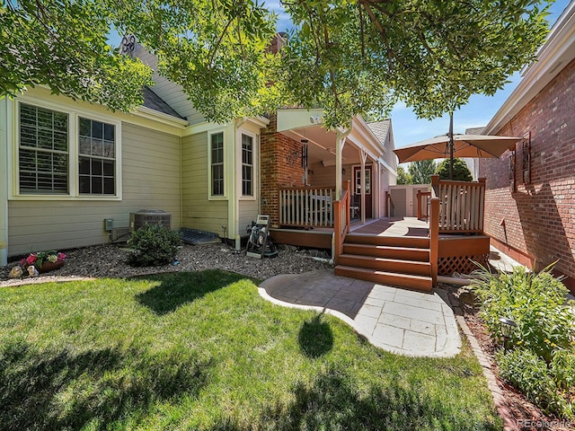 view of yard featuring a wooden deck and central AC