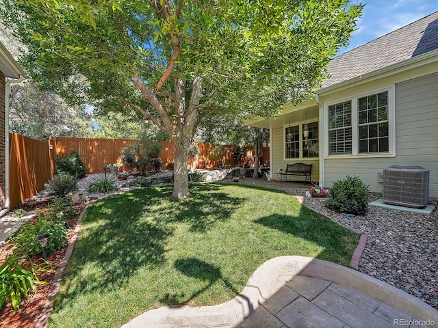 view of yard featuring central AC and a fenced backyard