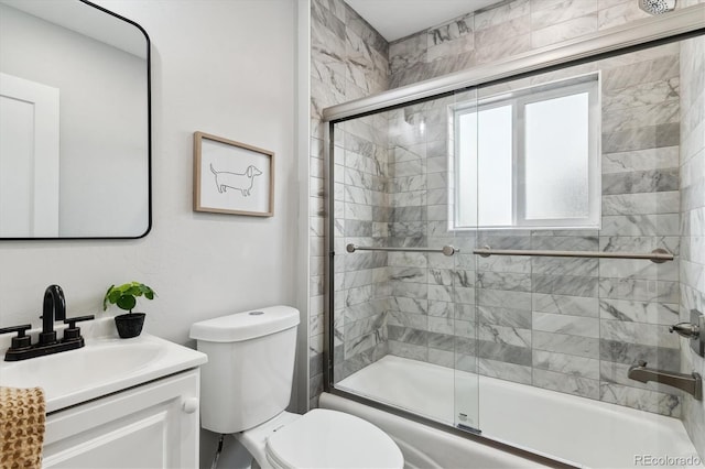 full bathroom featuring toilet, vanity, and bath / shower combo with glass door