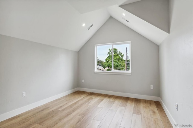 bonus room with vaulted ceiling and light wood-type flooring