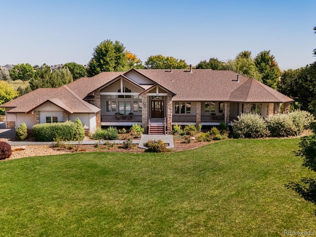 view of front of property with a front yard and covered porch