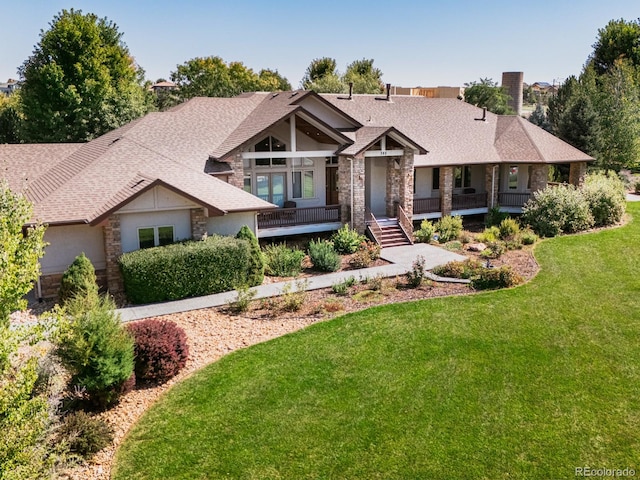 view of front of home with a front yard and covered porch