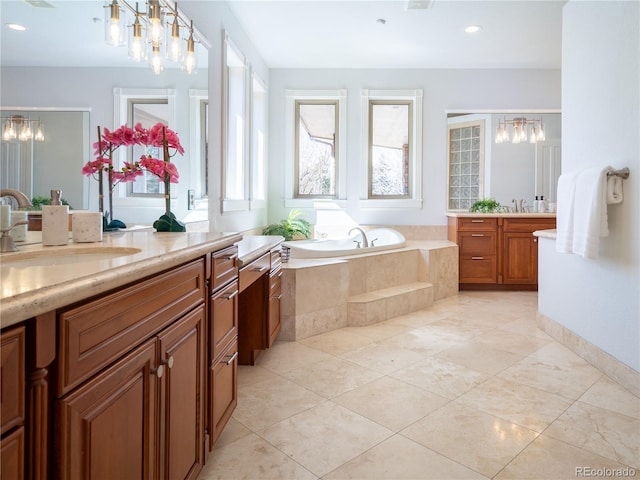 bathroom with tiled bath and vanity