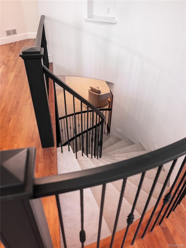 staircase featuring wood-type flooring