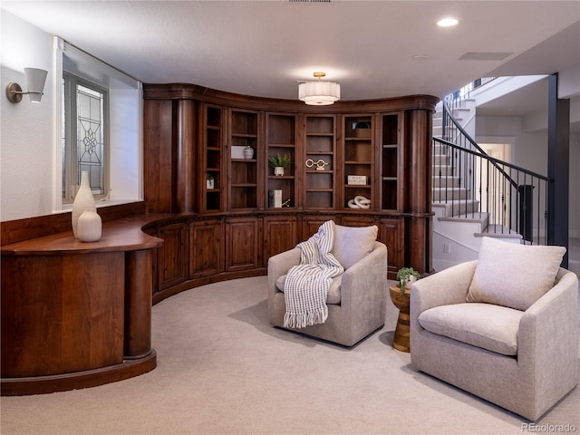 sitting room featuring light colored carpet