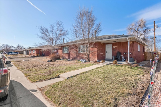 8609 W 54th Pl, Arvada, CO 80002 - single story home with brick siding, fence, and a front yard