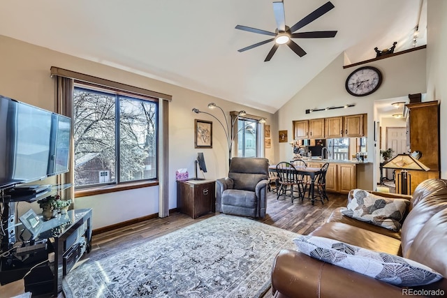 living room with dark wood-style floors, a ceiling fan, and a healthy amount of sunlight