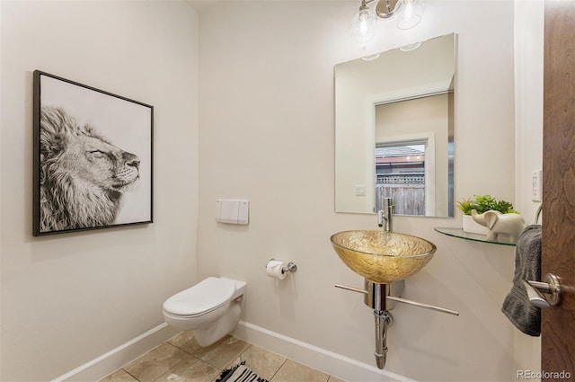 bathroom featuring sink, tile patterned floors, and toilet