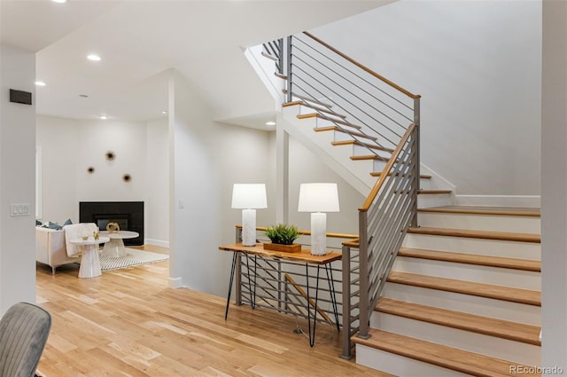 stairs featuring hardwood / wood-style flooring