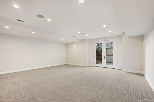 carpeted empty room featuring french doors