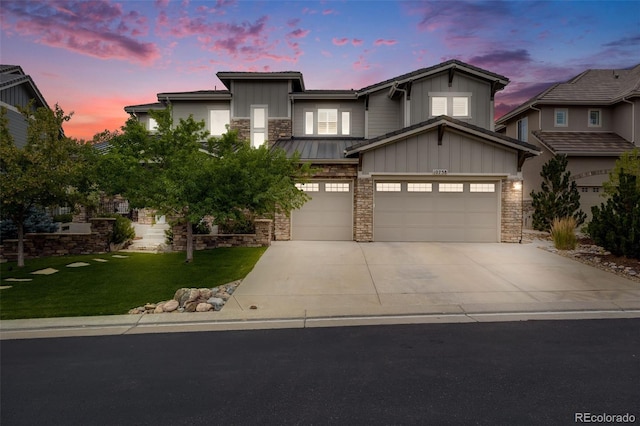 view of front of house with a garage and a lawn