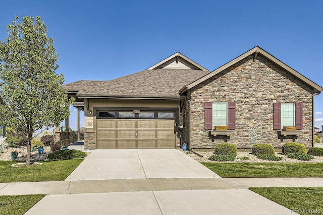 16459 W 86th Pl Unit B, Arvada, CO 80007 - view of front of home featuring an attached garage, driveway, stone siding, and a shingled roof