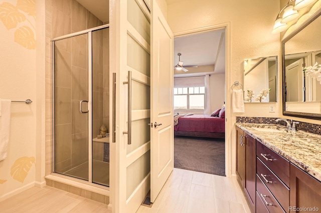 16459 W 86th Pl Unit B, Arvada, CO 80007 - bathroom featuring a stall shower, a ceiling fan, and vanity