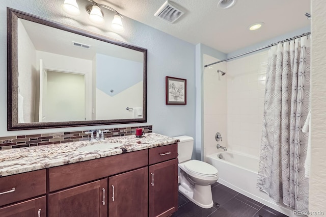 16459 W 86th Pl Unit B, Arvada, CO 80007 - full bath with decorative backsplash, toilet, vanity, tile patterned floors, and shower / bath combo with shower curtain