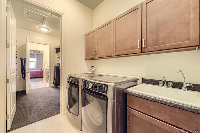 16459 W 86th Pl Unit B, Arvada, CO 80007 - laundry room with independent washer and dryer, cabinet space, attic access, and light carpet