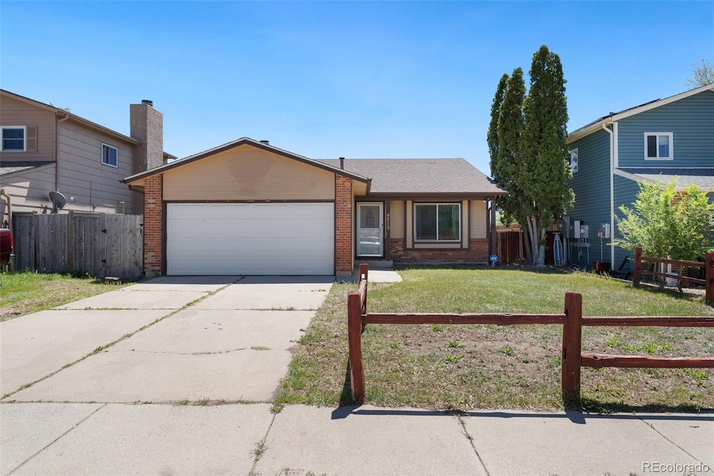 view of front of house featuring a garage and a front yard