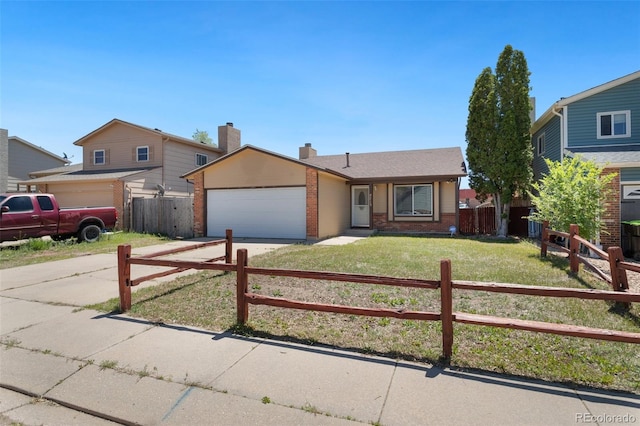 view of front of home featuring a garage and a front lawn