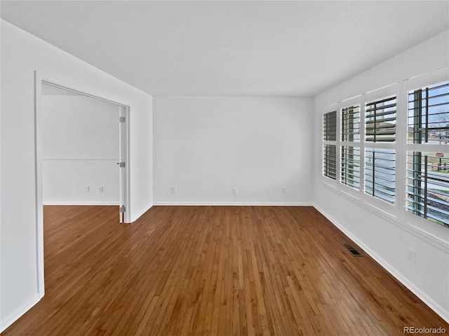 9115 W Hinsdale Pl, Littleton, CO 80128 - spare room featuring baseboards, hardwood / wood-style flooring, and visible vents