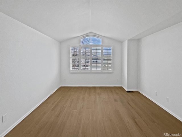 9115 W Hinsdale Pl, Littleton, CO 80128 - unfurnished room featuring baseboards, wood finished floors, and vaulted ceiling