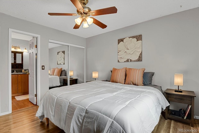 bedroom with ceiling fan, wood-type flooring, and a closet