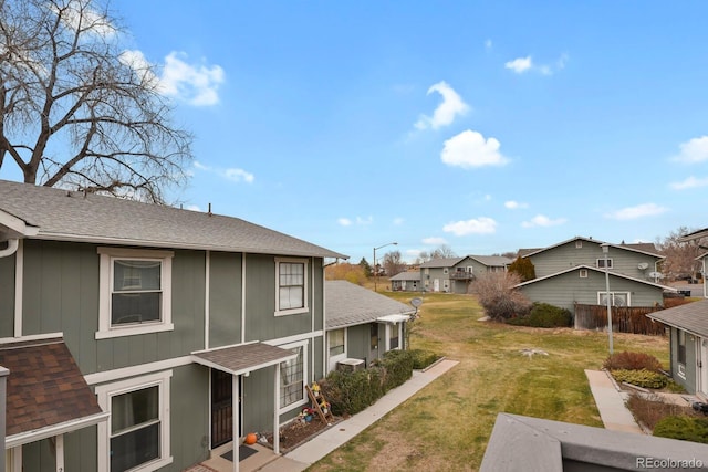 view of side of home with a yard