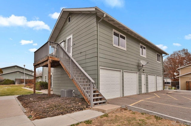 view of home's exterior with a garage and central air condition unit