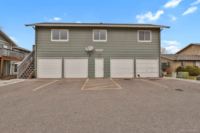 rear view of property featuring a garage