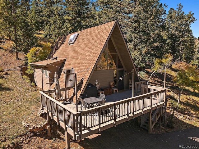 back of property with a wooden deck