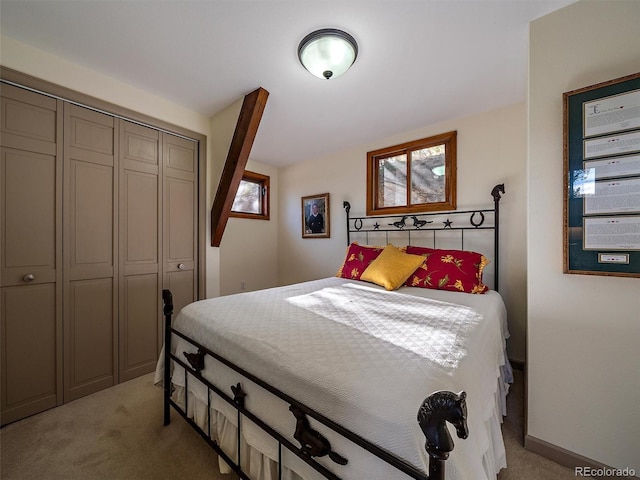 bedroom featuring light colored carpet and a closet