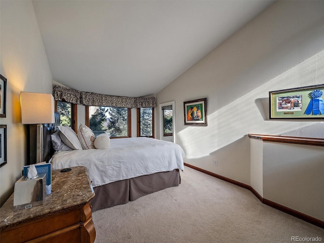 bedroom featuring lofted ceiling and carpet floors