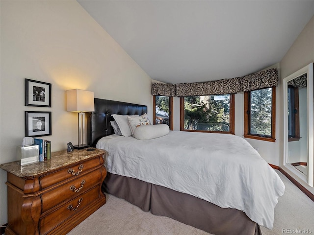 carpeted bedroom featuring vaulted ceiling