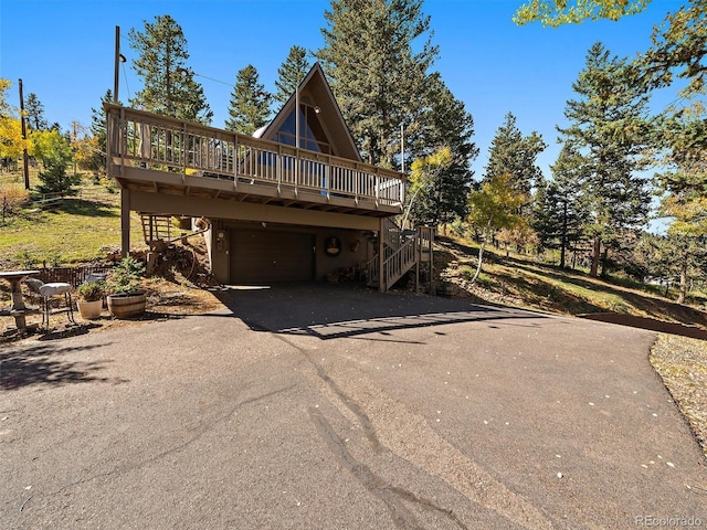 exterior space featuring a garage and a deck