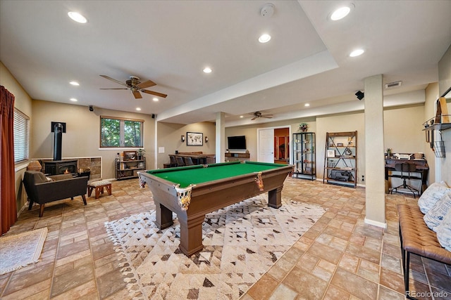 1248 Rawhide Cir, Elizabeth, CO 80107 - recreation room with a ceiling fan, a wood stove, recessed lighting, billiards, and light stone finish flooring