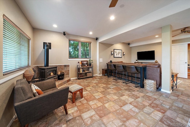 1248 Rawhide Cir, Elizabeth, CO 80107 - living area with a ceiling fan, a wood stove, stone tile flooring, and recessed lighting