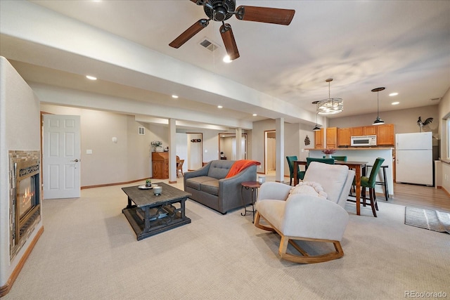 1248 Rawhide Cir, Elizabeth, CO 80107 - living area featuring light carpet, ceiling fan, recessed lighting, and a glass covered fireplace