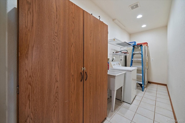 1248 Rawhide Cir, Elizabeth, CO 80107 - laundry room with washer / dryer, light tile patterned floors, and recessed lighting