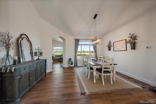 1248 Rawhide Cir, Elizabeth, CO 80107 - dining space featuring vaulted ceiling, arched walkways, a chandelier, and dark wood-type flooring
