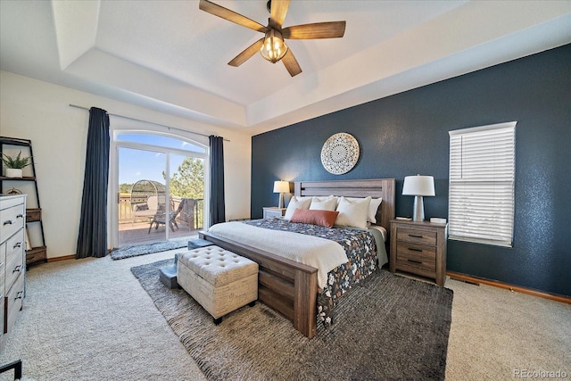 1248 Rawhide Cir, Elizabeth, CO 80107 - carpeted bedroom featuring a raised ceiling, access to exterior, and ceiling fan